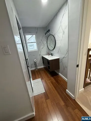 a view of living room with wooden floor and furniture