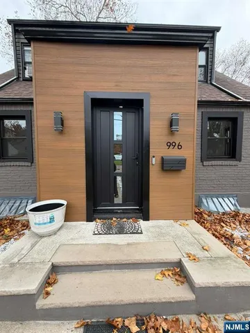 a view of a brick house with potted plants