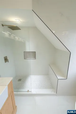 a bathroom with a bathtub and shower
