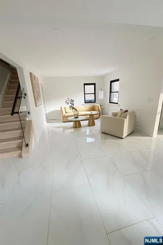 a living room with furniture and white walls