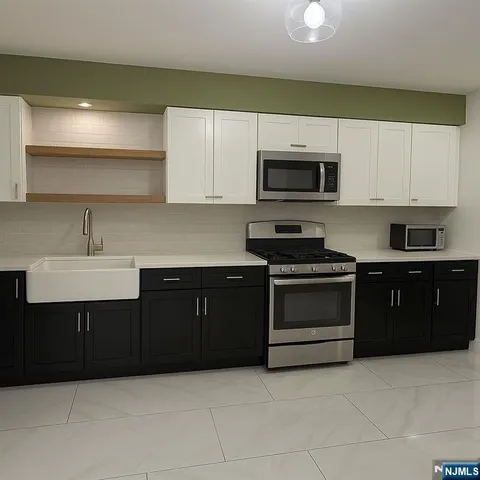 a kitchen with a sink and a stove top oven
