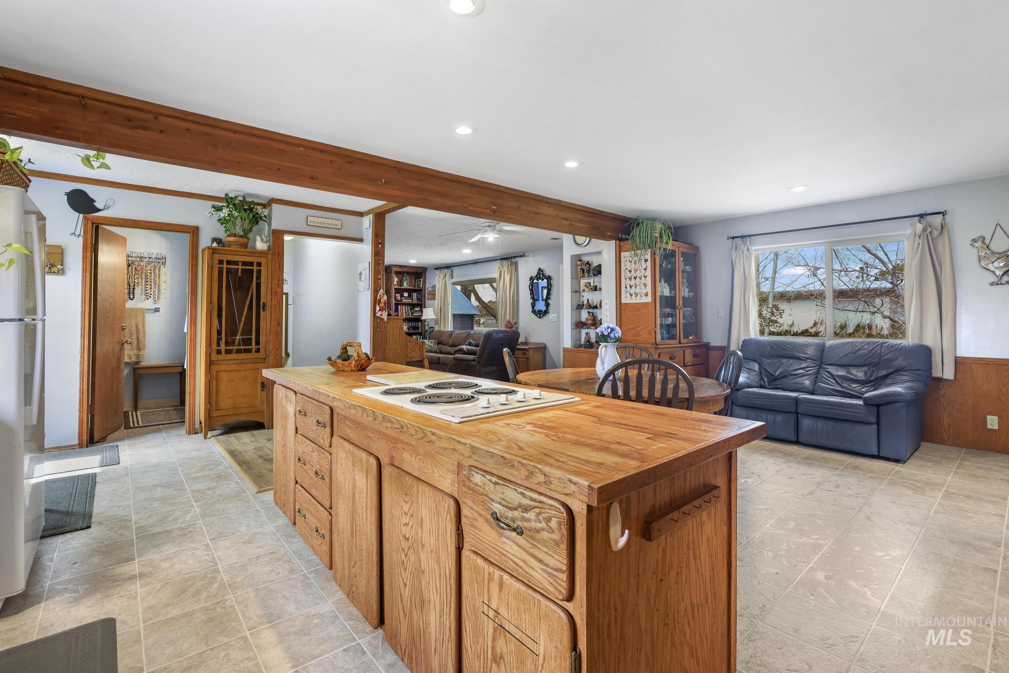 19591 Queen Crown Road Carey, ID 83320 - Photo 8 of 37 Central kitchen island with wood-finish cabinetry and integrated cooktop