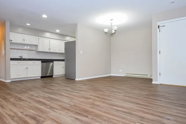 a view of a kitchen with a sink and a refrigerator