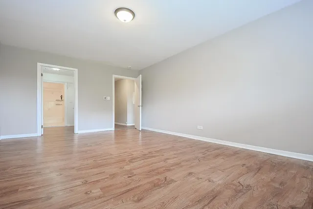 a view of an empty room and wooden floor