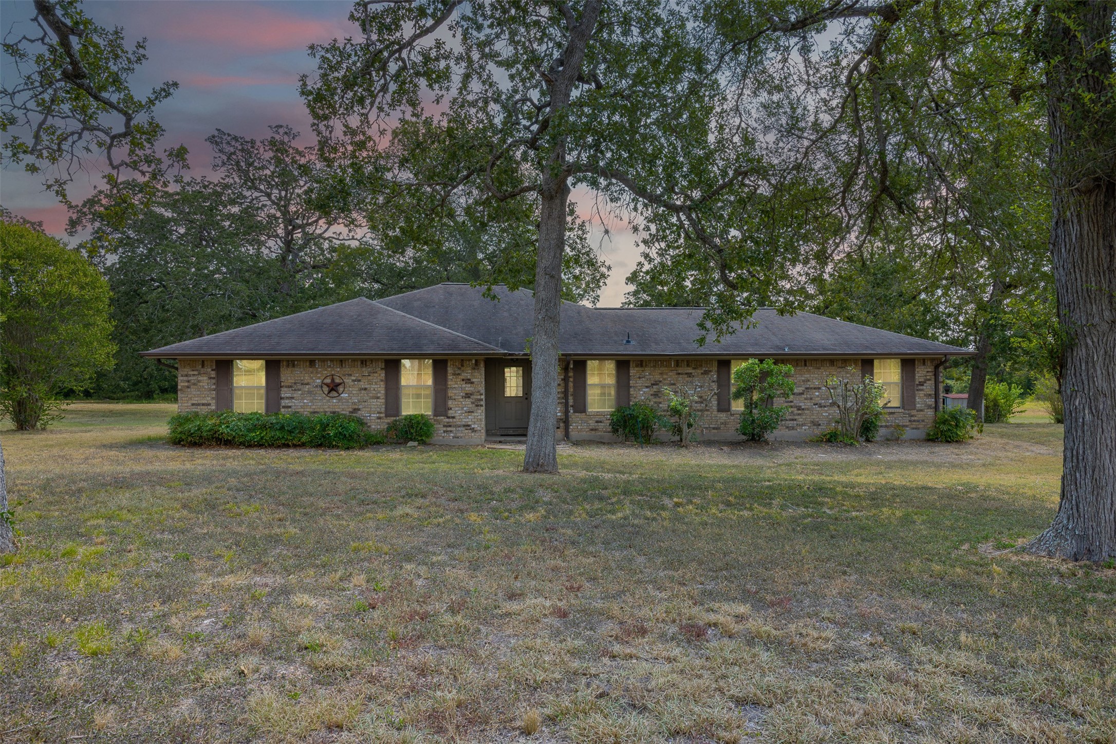 3300 Hills Road Carmine, TX 78932 - Photo 2 of 25 a front view of a house with a garden
