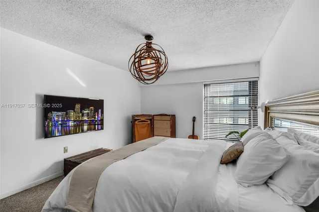 a bedroom with a bed and a wall painting