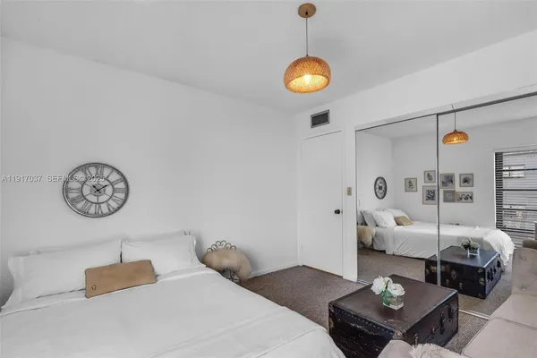 a bedroom with furniture and wooden floor