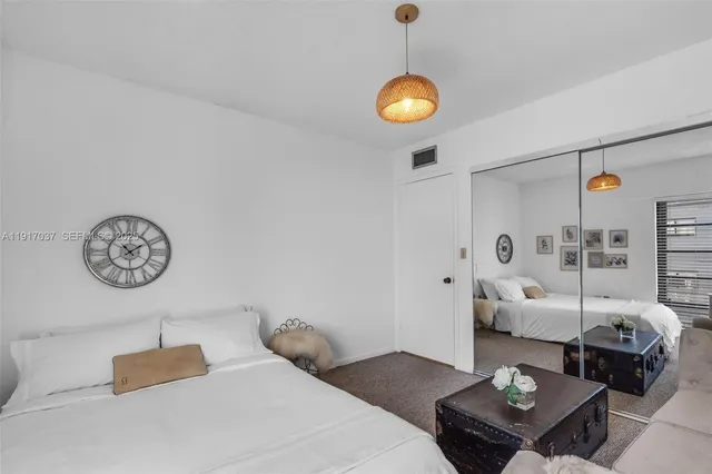 a bedroom with furniture and wooden floor