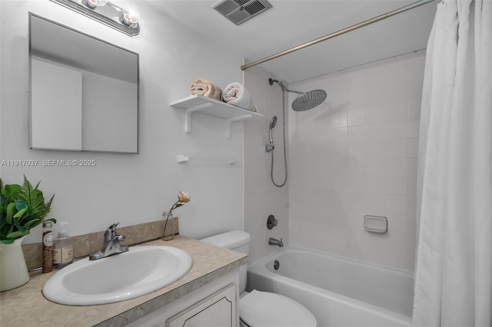 575 Crandon Boulevard, Unit 504 Key Biscayne, FL 33149 - Photo 22 of 46 a bathroom with a sink toilet and shower