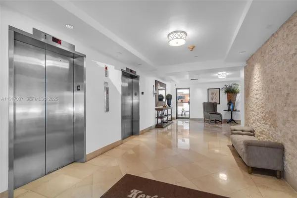 a lobby with a couch and a view of living room