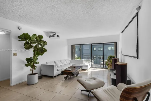 a living room with furniture and potted plant