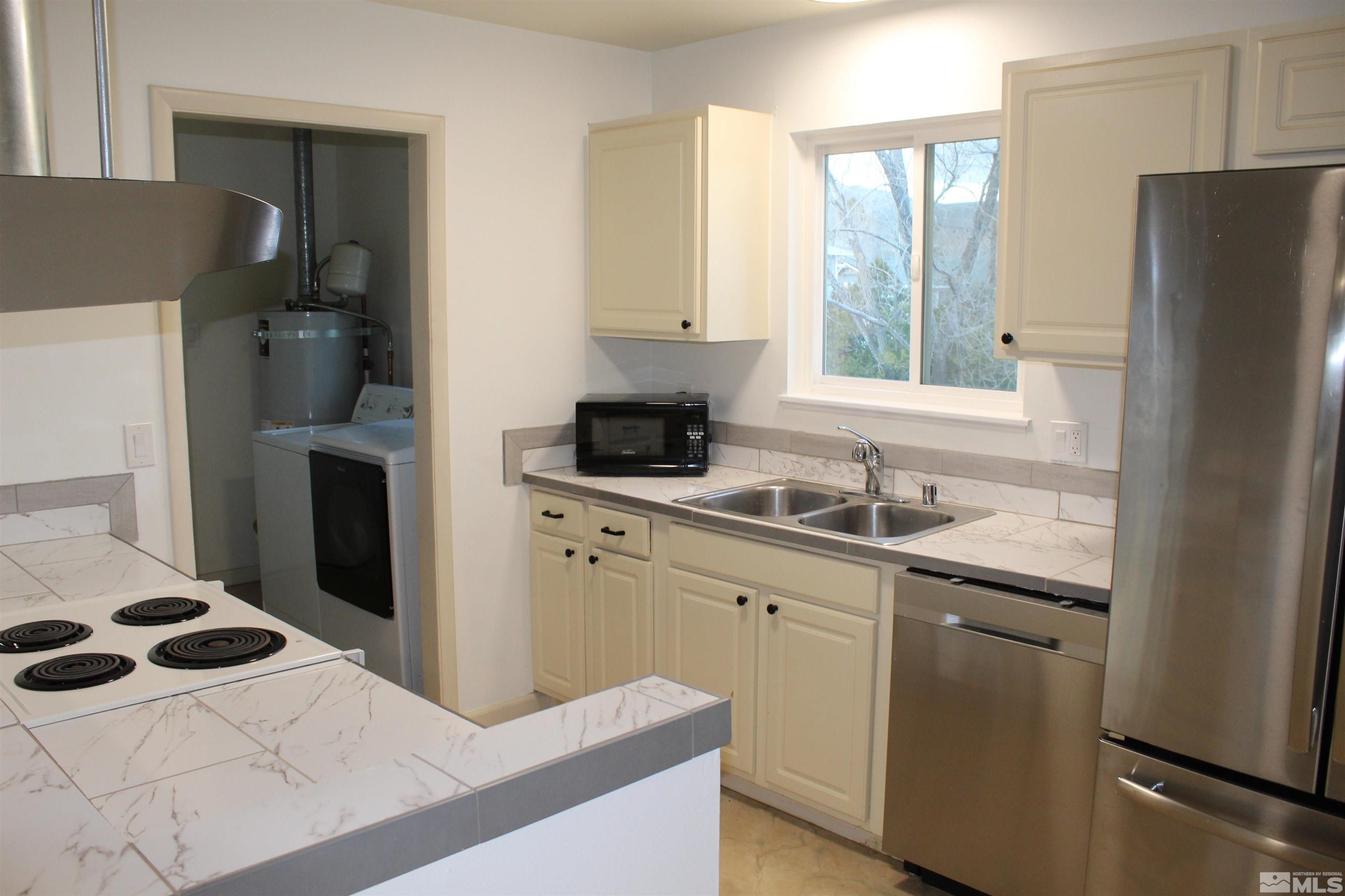 3660 Downey Avenue Reno, NV 89503 - Photo 4 of 19 a kitchen with a refrigerator and a sink