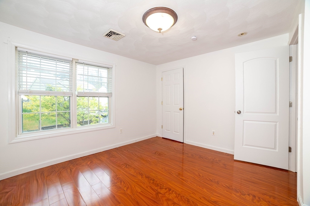 41 Mohave Road Worcester, MA 01606 - Photo 21 of 30 an empty room with wooden floor and windows