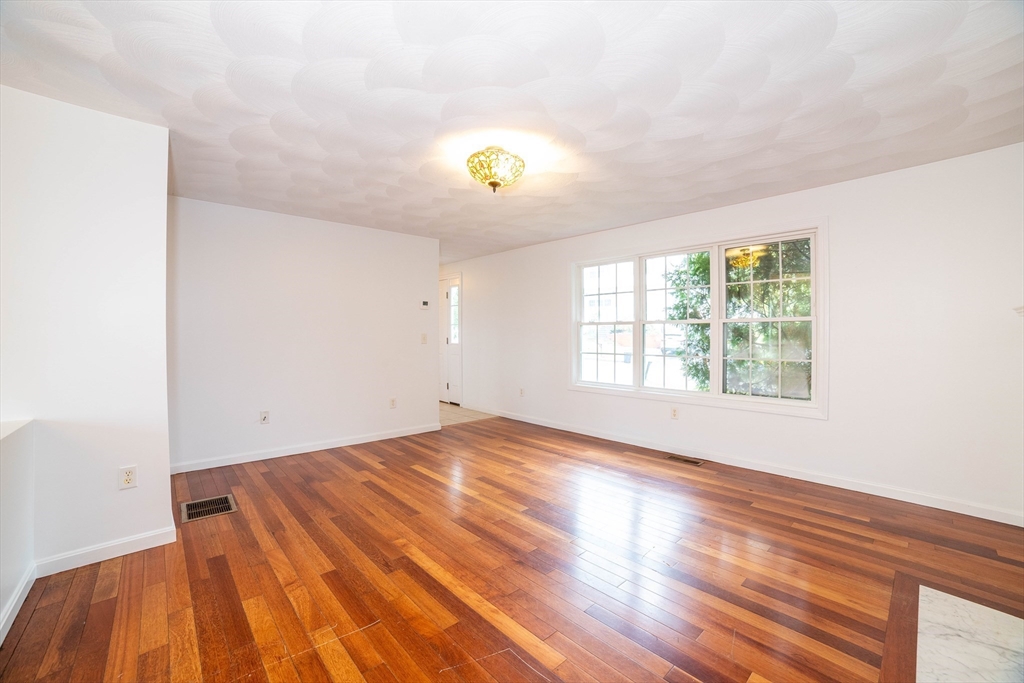 41 Mohave Road Worcester, MA 01606 - Photo 3 of 30 a view of an empty room with window and wooden floor