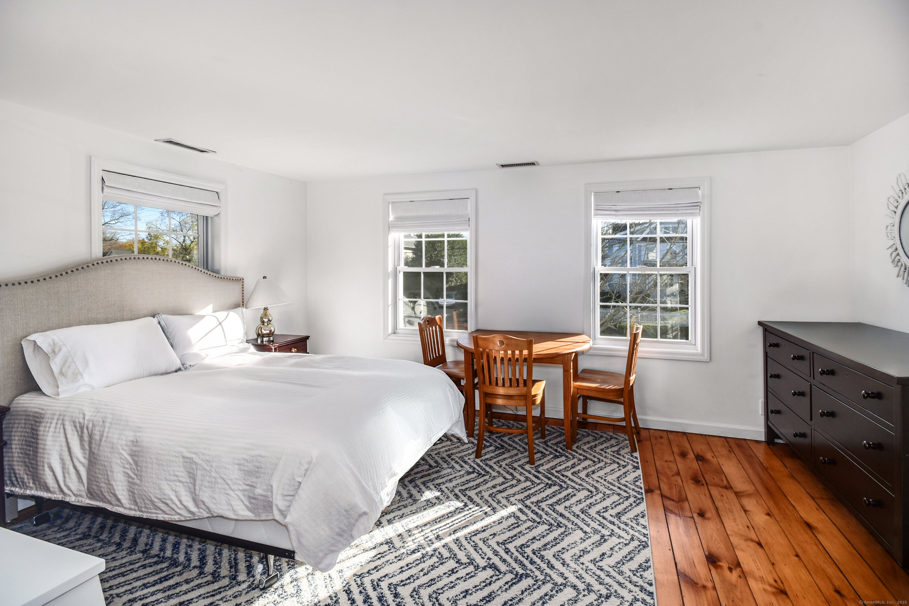 60 East Avenue New Canaan, CT 06840 - Photo 16 of 24 a bedroom with a bed and a dresser next to a window