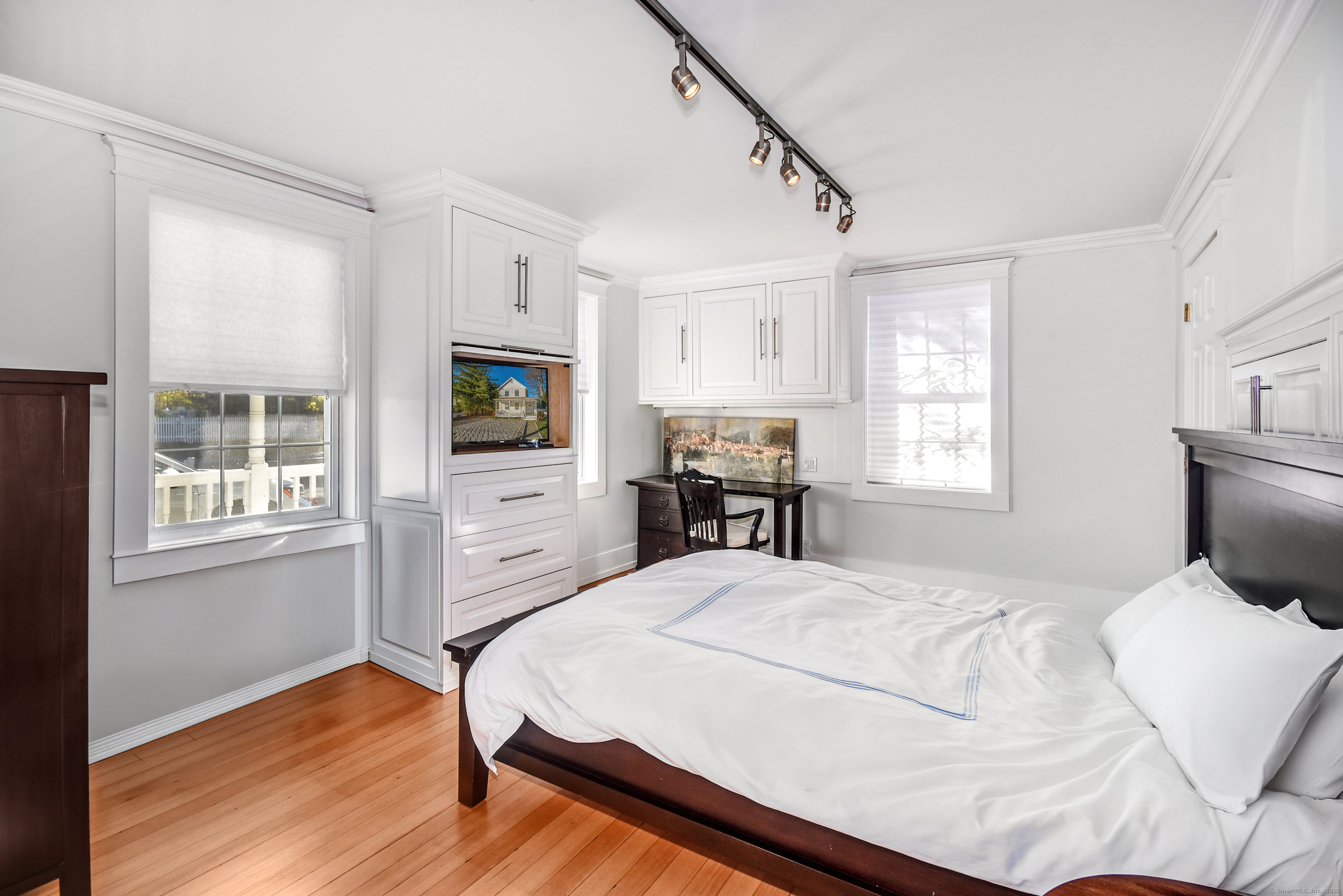 60 East Avenue New Canaan, CT 06840 - Photo 7 of 24 a bedroom with a bed windows and a television