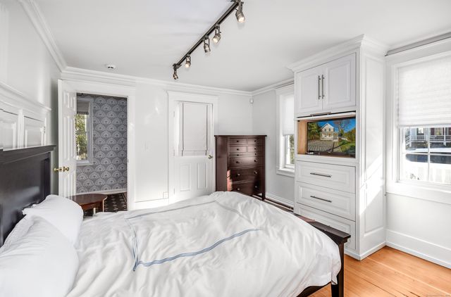 a bedroom with a bed and a flat screen tv