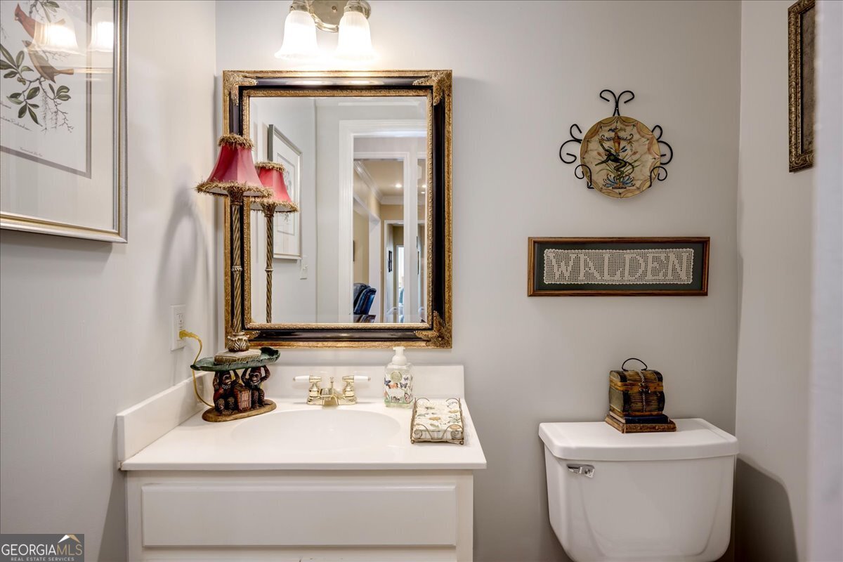 1490 Country Club Circle Wrens, GA 30833 - Photo 12 of 40 a bathroom with a toilet sink and mirror
