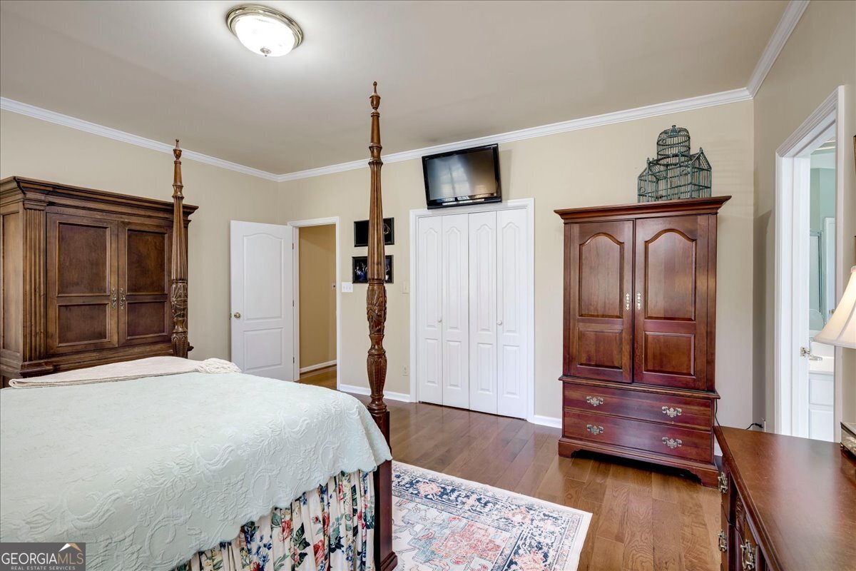 1490 Country Club Circle Wrens, GA 30833 - Photo 19 of 40 a bedroom with a bed and wooden floor