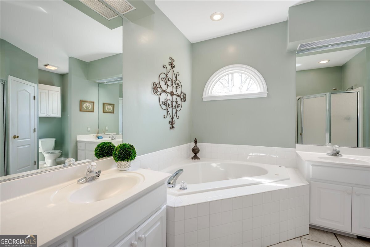 1490 Country Club Circle Wrens, GA 30833 - Photo 20 of 40 a bathroom with a sink and a mirror