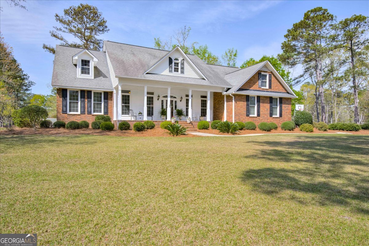 1490 Country Club Circle Wrens, GA 30833 - Photo 2 of 40 a front view of a house with a garden