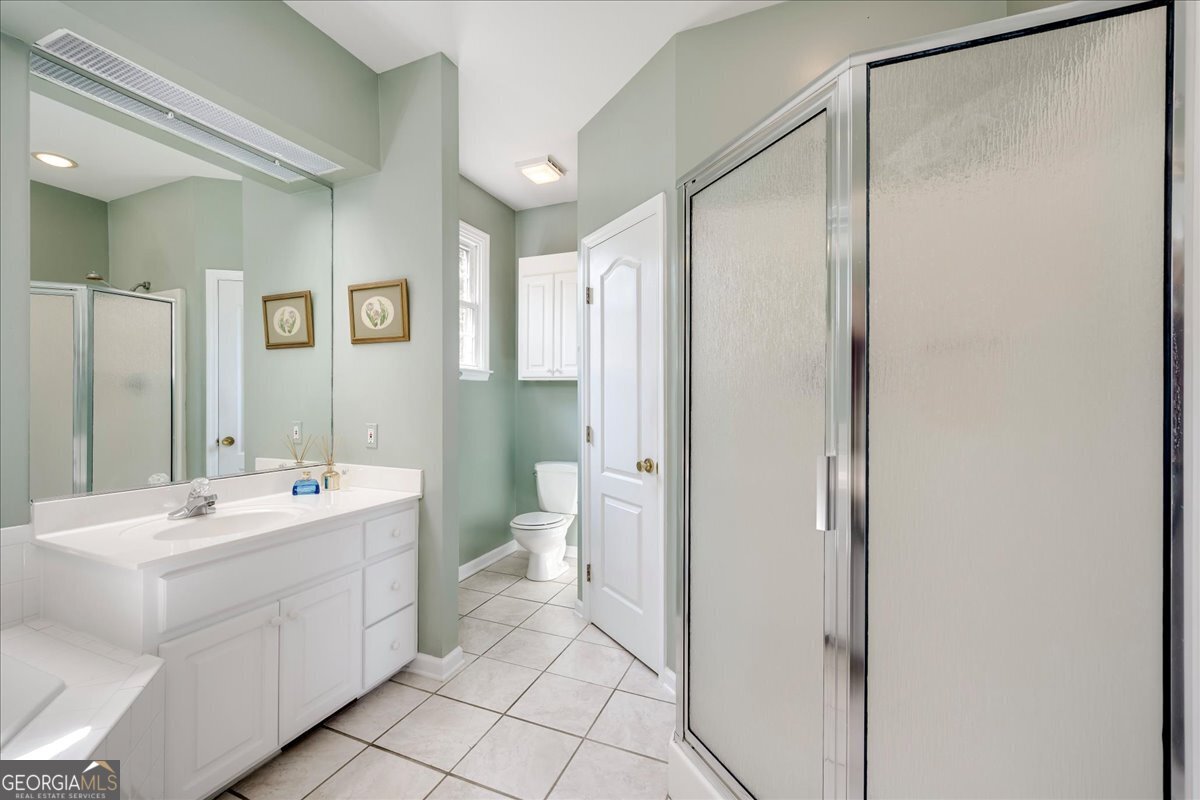 1490 Country Club Circle Wrens, GA 30833 - Photo 21 of 40 a bathroom with a double vanity sink mirror and toilet