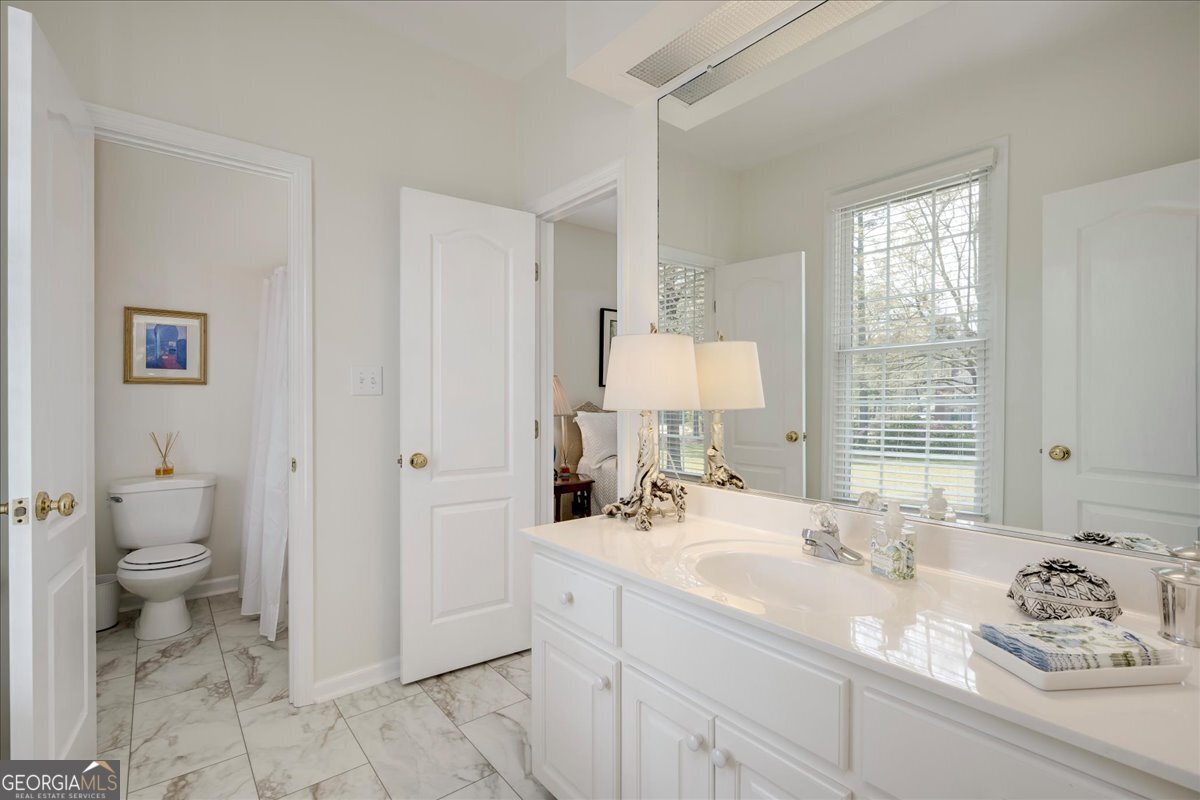 1490 Country Club Circle Wrens, GA 30833 - Photo 23 of 40 a bathroom with a sink toilet and shower
