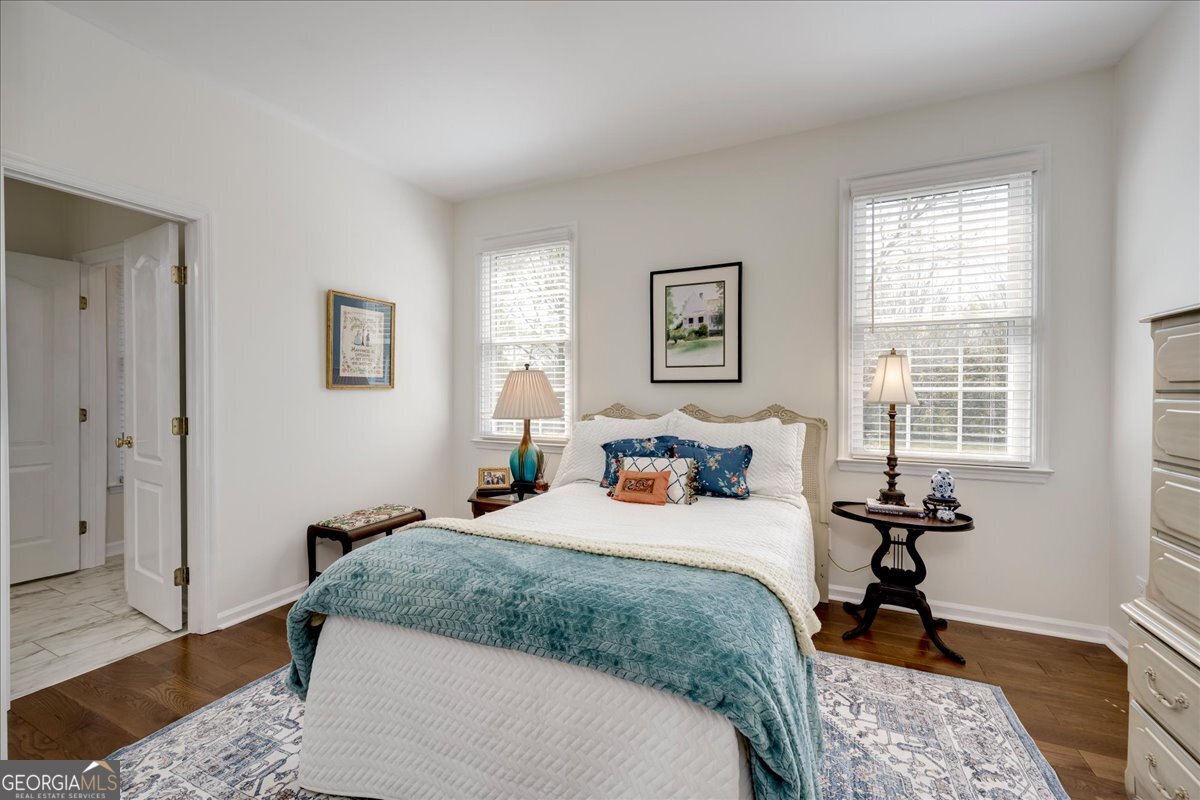 1490 Country Club Circle Wrens, GA 30833 - Photo 24 of 40 a bedroom with a bed a table and chair
