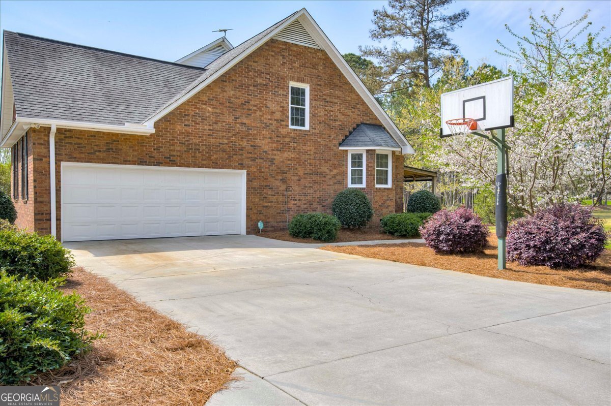 1490 Country Club Circle Wrens, GA 30833 - Photo 30 of 40 a front view of a house with a yard and garage