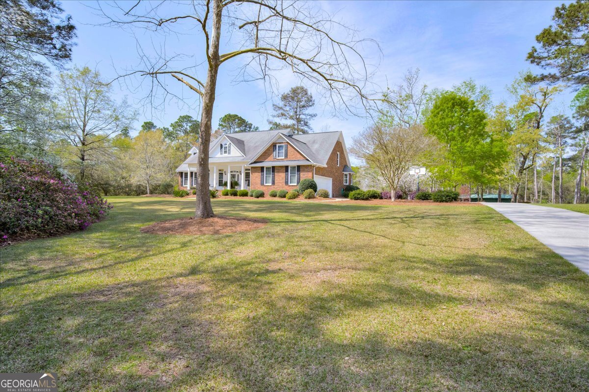 1490 Country Club Circle Wrens, GA 30833 - Photo 3 of 40 a front view of a house with a yard
