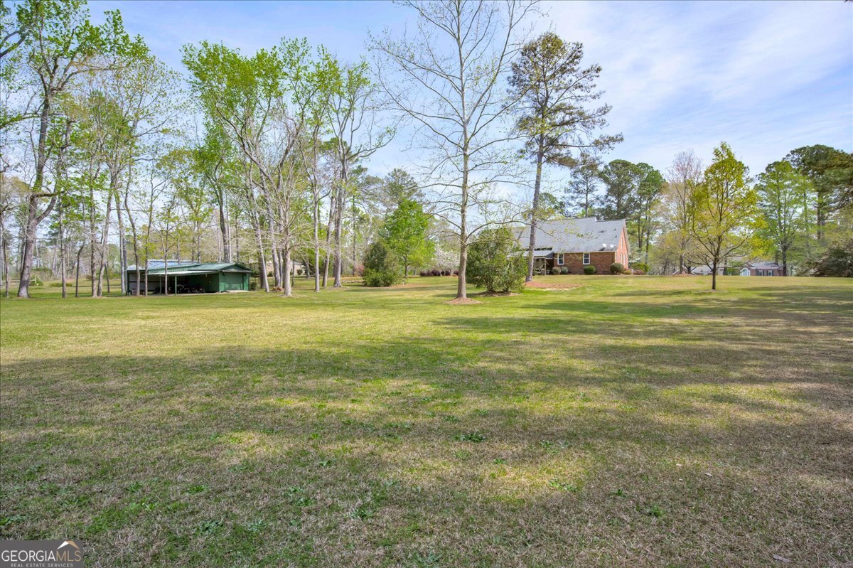 1490 Country Club Circle Wrens, GA 30833 - Photo 38 of 40 a grassy field with trees in the background