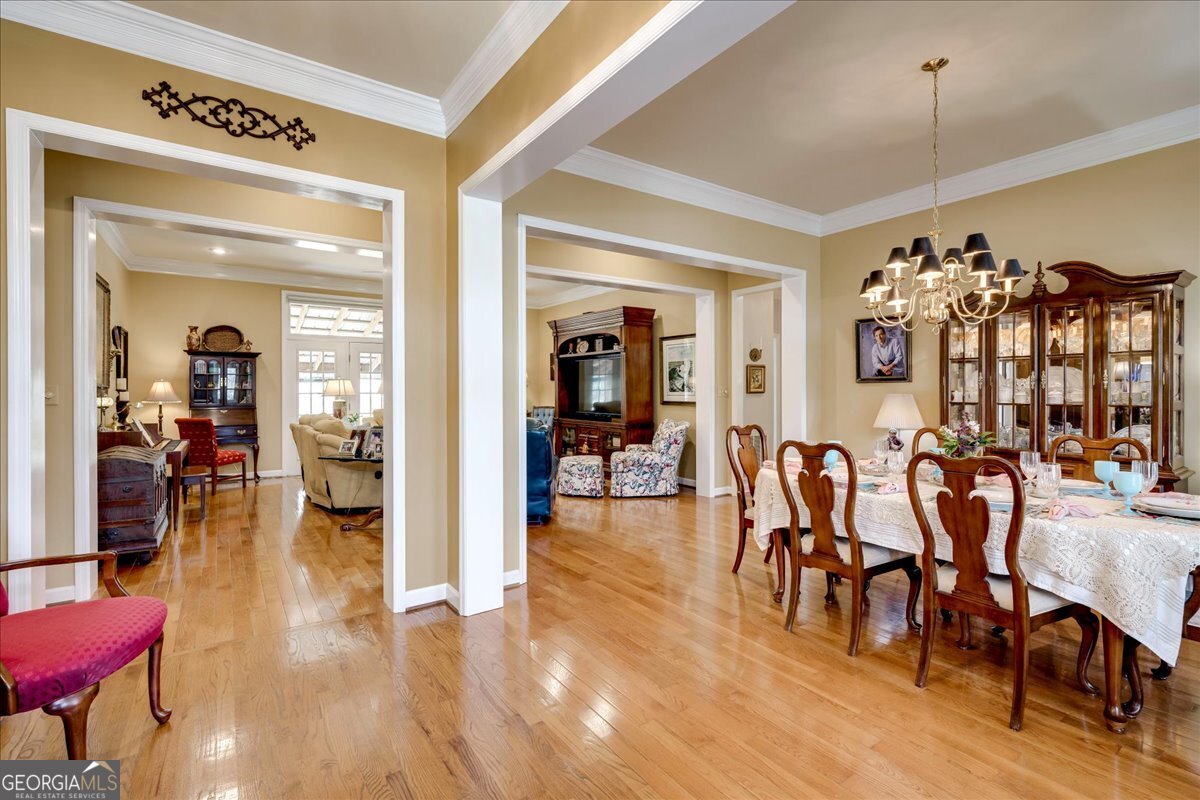 1490 Country Club Circle Wrens, GA 30833 - Photo 6 of 40 a view of a dining room and livingroom with furniture wooden floor a chandelier
