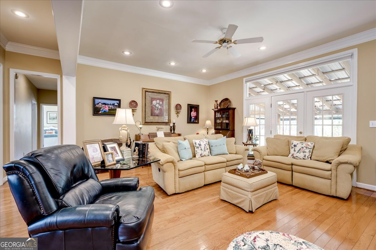 1490 Country Club Circle Wrens, GA 30833 - Photo 10 of 40 a living room with furniture ceiling fan and a rug