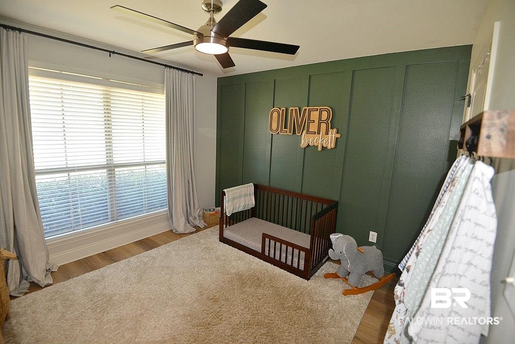 11201 Herschel Loop Daphne, AL 36526 - Photo 17 of 32 Bedroom featuring a nursery area, wood-type flooring, and ceiling fan