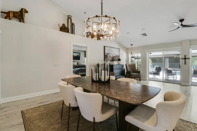 a kitchen with stainless steel appliances a refrigerator and wooden floor