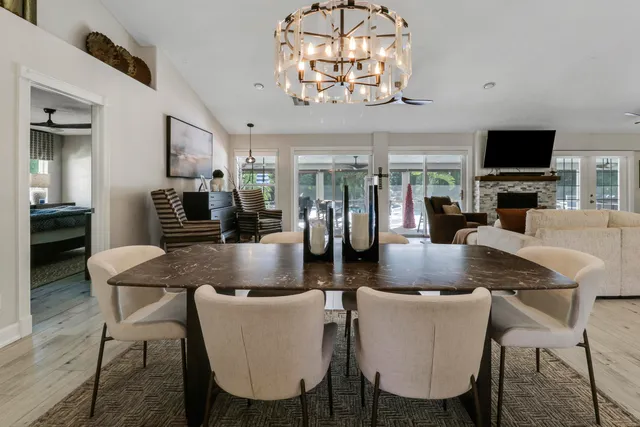 a kitchen with stainless steel appliances white cabinets and a wooden floor