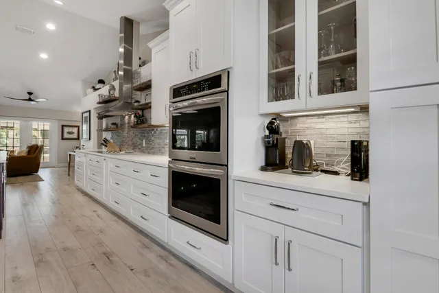 a bathroom with a double vanity sink a mirror a shower and a bathtub