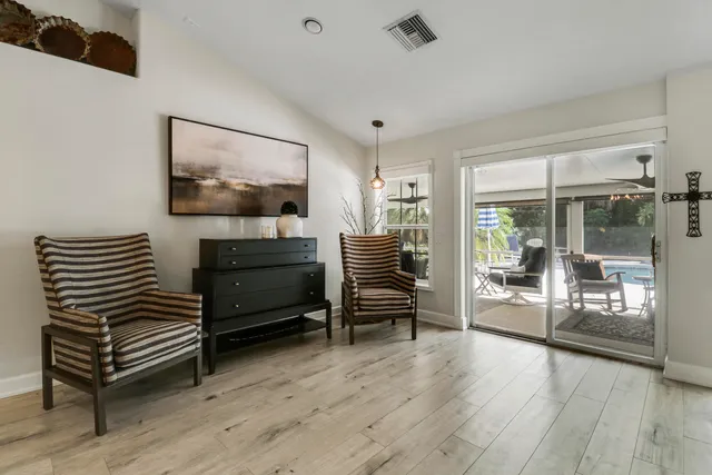 a living room with furniture and a view of kitchen
