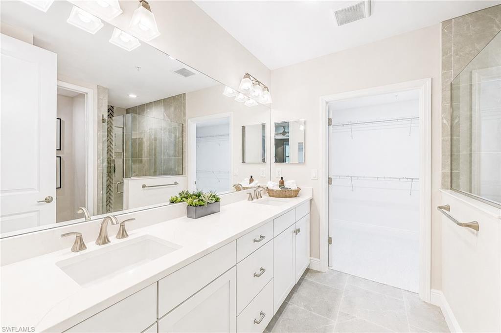 2620 Seychelles Circle, Unit 1302 Naples, FL 34112 - Photo 17 of 43 a bathroom with a double vanity sink mirror and double