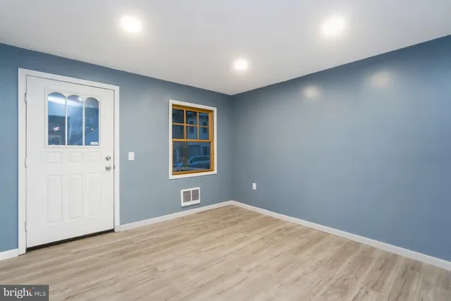 an empty room with windows and closet