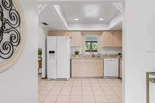 a kitchen with a refrigerator and a sink