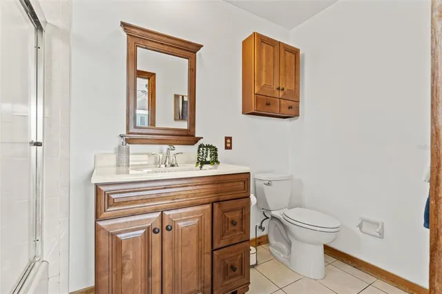 a bathroom with a sink mirror vanity and toilet