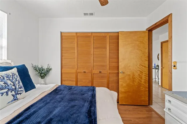 a bedroom with a bed and wooden floor