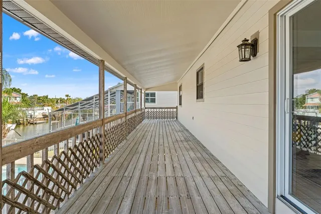 a view of a balcony and floor to ceiling window next to a city view