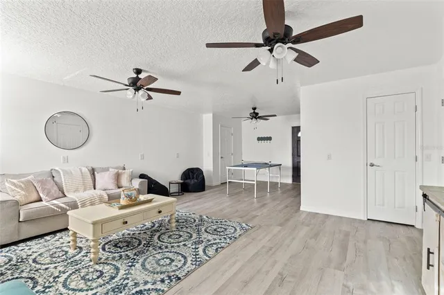 a living room with furniture and a wooden floor