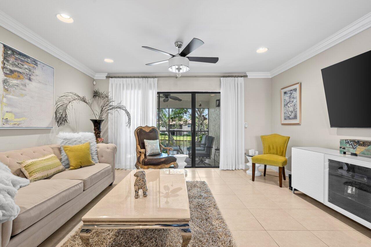 9261 Vista Del Lago, Unit H Boca Raton, FL 33428 - Photo 12 of 27 a living room with furniture and a flat screen tv