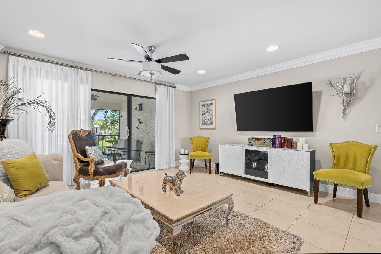 9261 Vista Del Lago, Unit H Boca Raton, FL 33428 - Photo 13 of 27 a living room with furniture and a flat screen tv