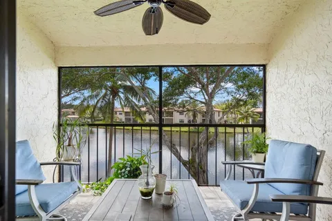 a view of a balcony with furniture and wooden floor