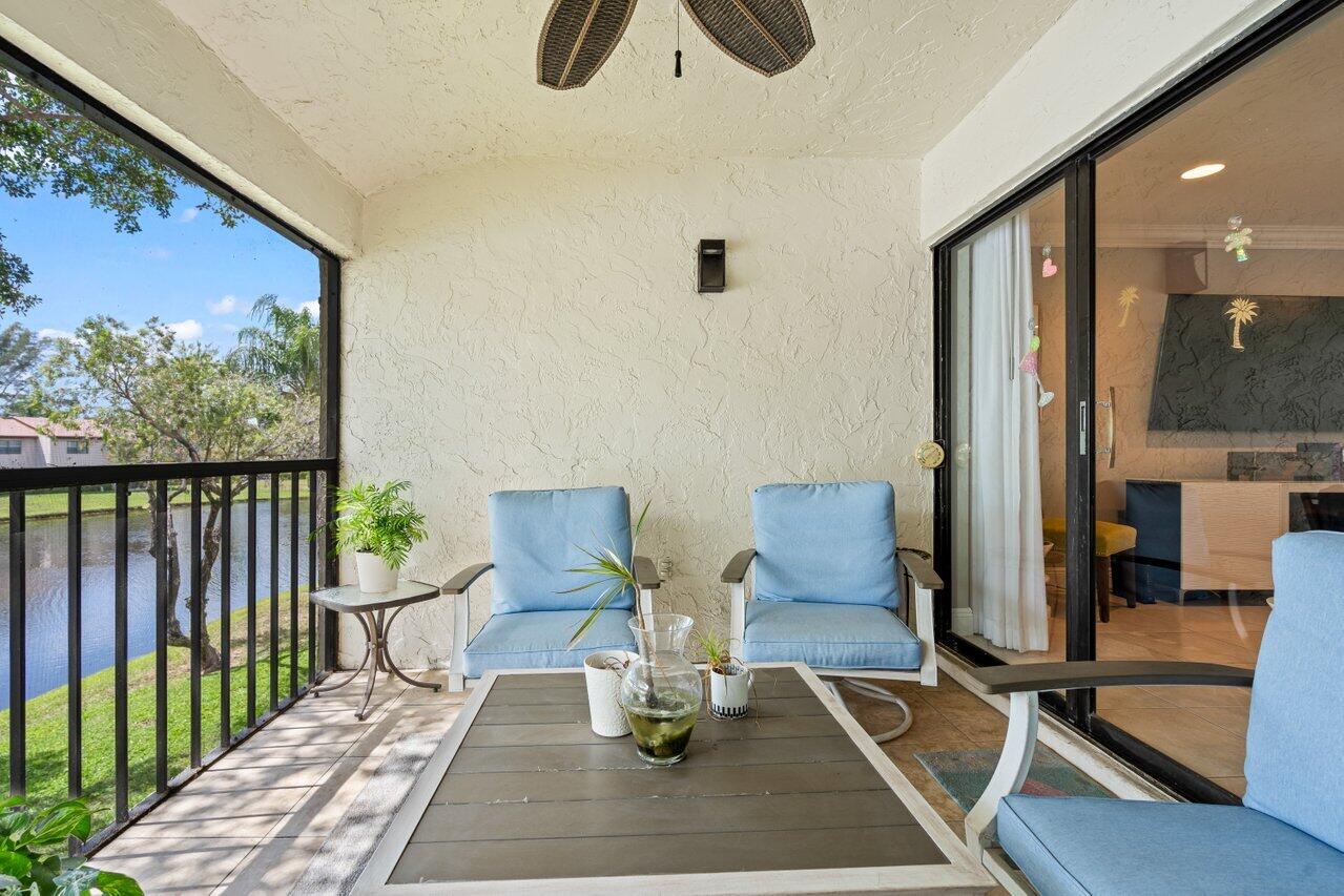 9261 Vista Del Lago, Unit H Boca Raton, FL 33428 - Photo 23 of 27 a view of workspace with wooden floor windows
