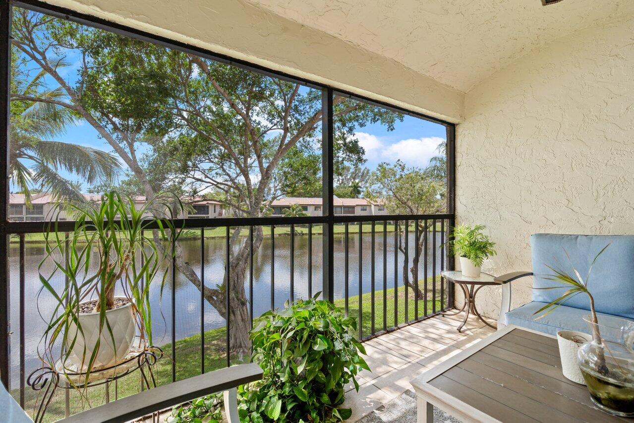 9261 Vista Del Lago, Unit H Boca Raton, FL 33428 - Photo 24 of 27 a view of a balcony with lake view and the back